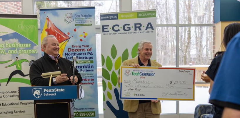 Brian Slawin and Bob Dornich present the $10,000 TechCelerator first-prize check to Eventio at Penn State Behrend